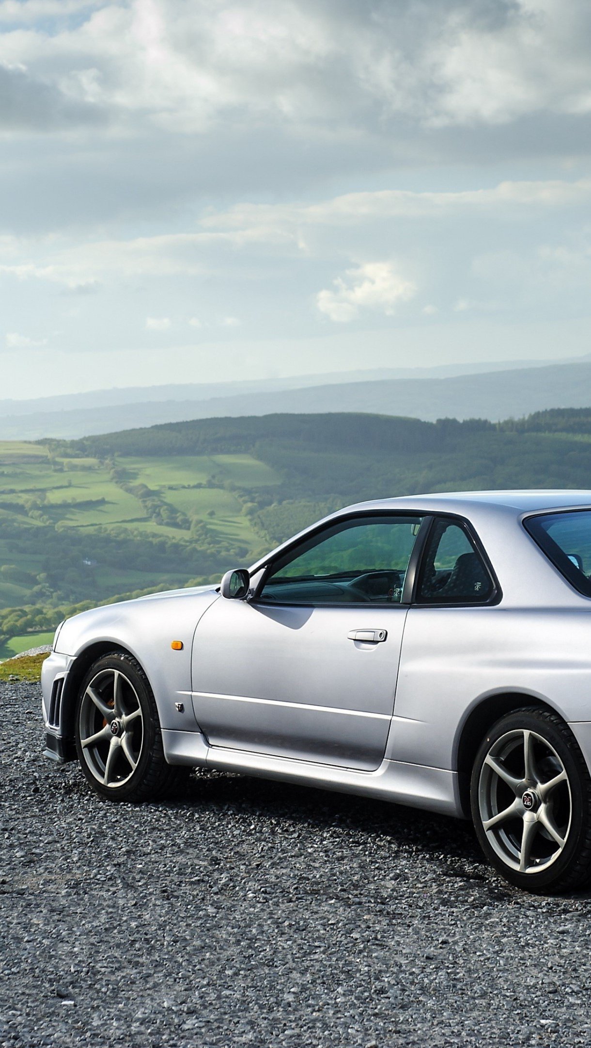 Nissan Skyline GT R gris de lado