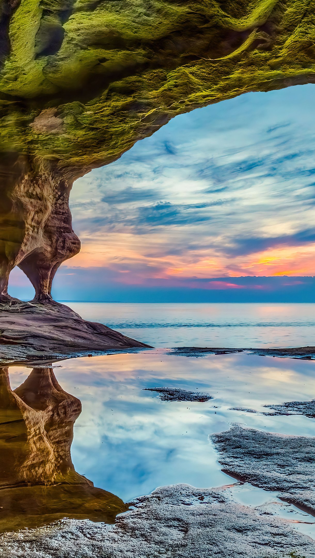 Playa al atardecer a través de rocas